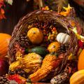 Wicker cornucopia filled with fall fruit and gourds