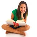 Teenager holding a book and smiling
