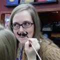 Leah B having a mustache painted on her face