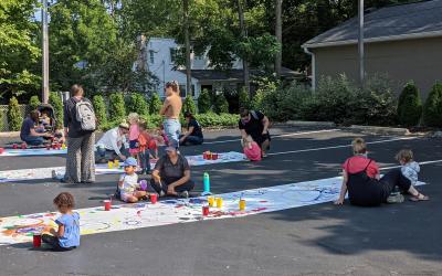 Families painting in parking lot across from Old Worthington Library