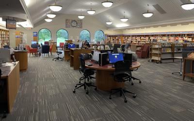View of computers and bookshelves in the popular library