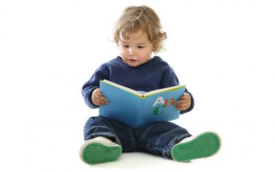 Toddler boy holding a book