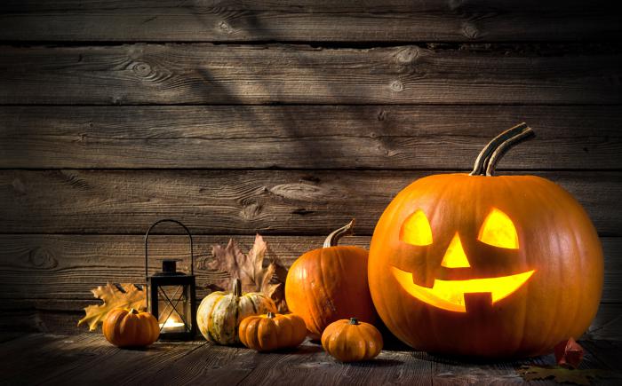Fall scene of pumpkins, leaves and a lantern