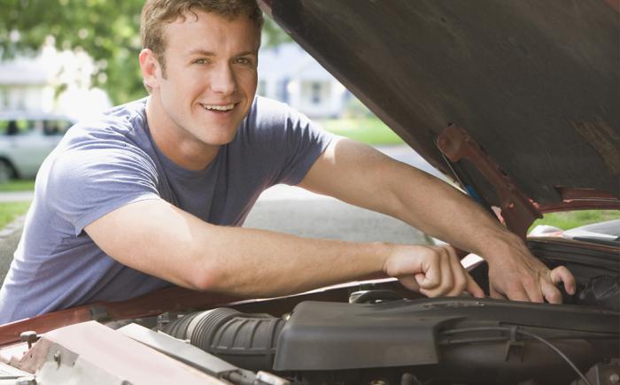 Man working on a vehicle engine