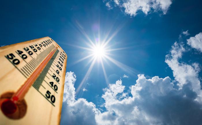 Sun shining down on a thermometer