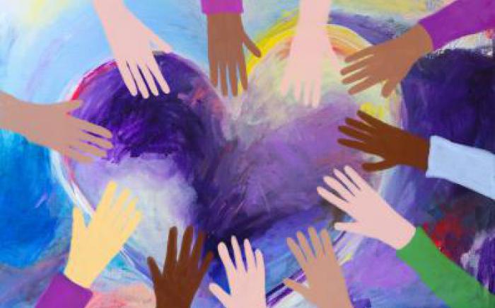 Illustration of different colored hands over a heart shape