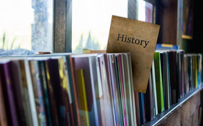 Books on shelf with a History label