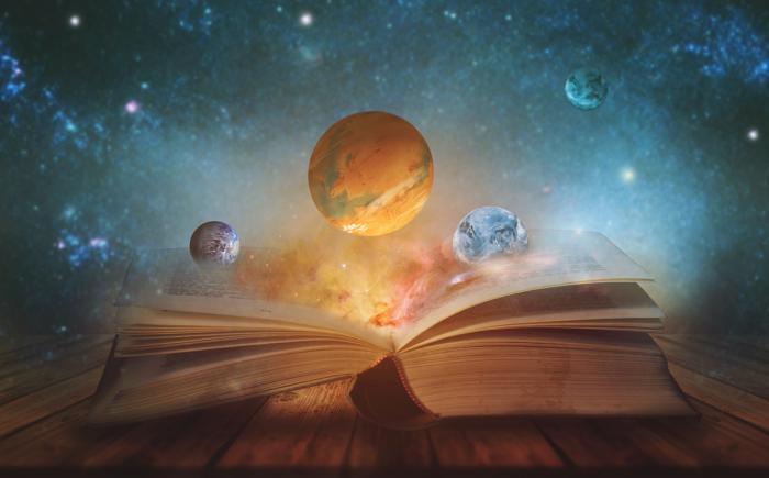 Thick book with planets floating above it against a space-y background