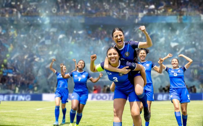 Women's soccer team celebrates in crowded stadium