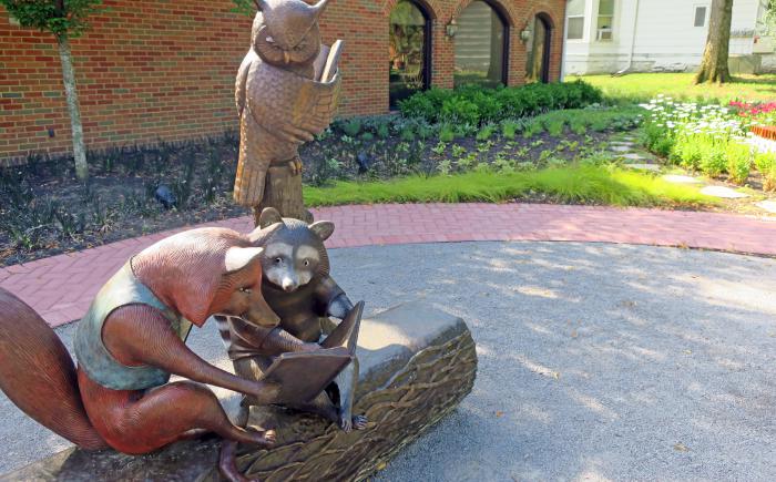 Reading with Friends sculpture with library in background