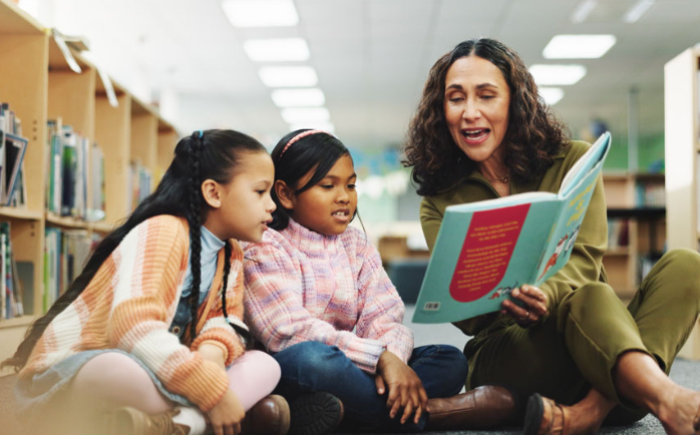 Teacher reading to two students
