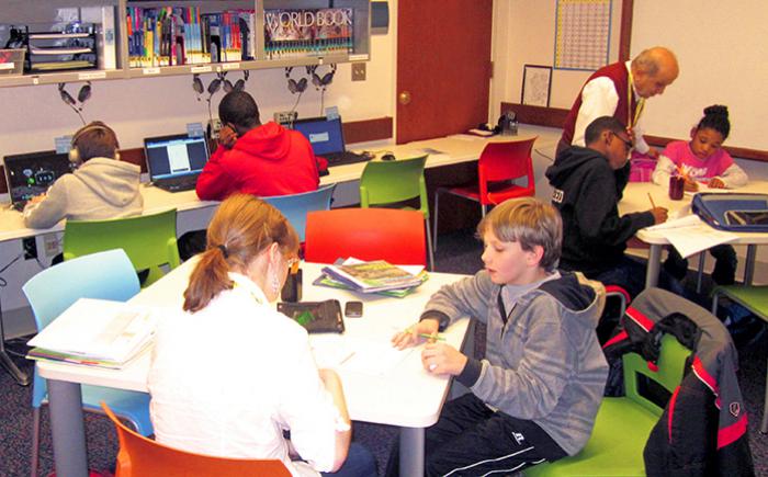 Students sitting at tables inside the Northwest Library Learning Lab