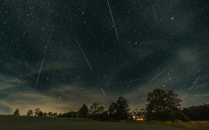 A meteor shower occurring over a field