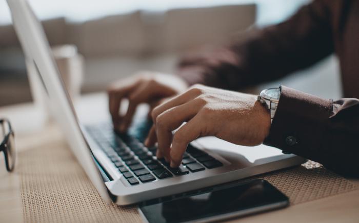 Hands typing on a keyboard
