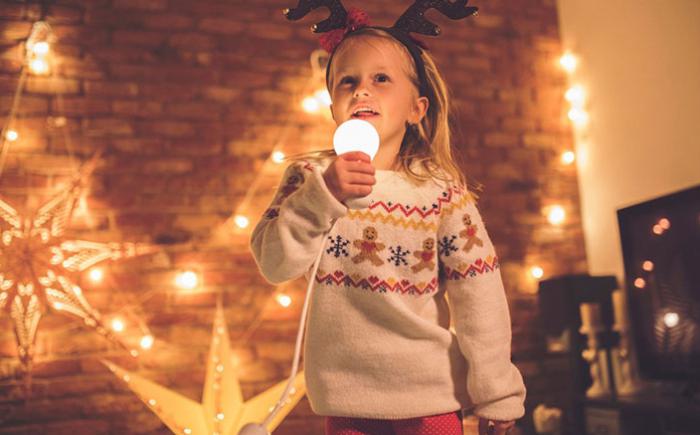 Child using a light bulb as a microphone
