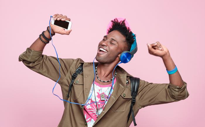 Man wearing headphones and dancing with arms in air