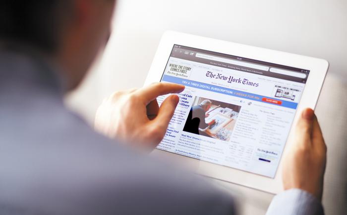 Man viewing the New York Times on a tablet