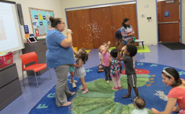A group of children catching bubbles