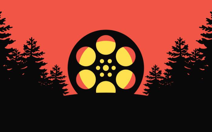 An oversized film reel, superimposed over the sun, surrounded by trees