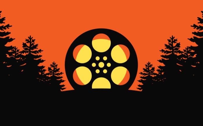 Film reel on a hill surrounded by trees
