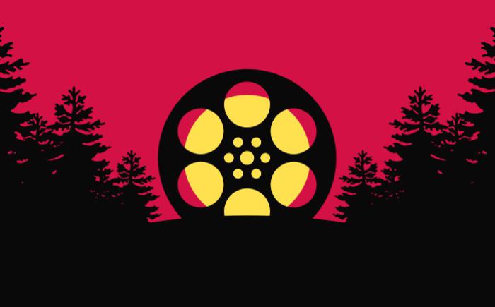 Film reel on a hill surrounded by trees
