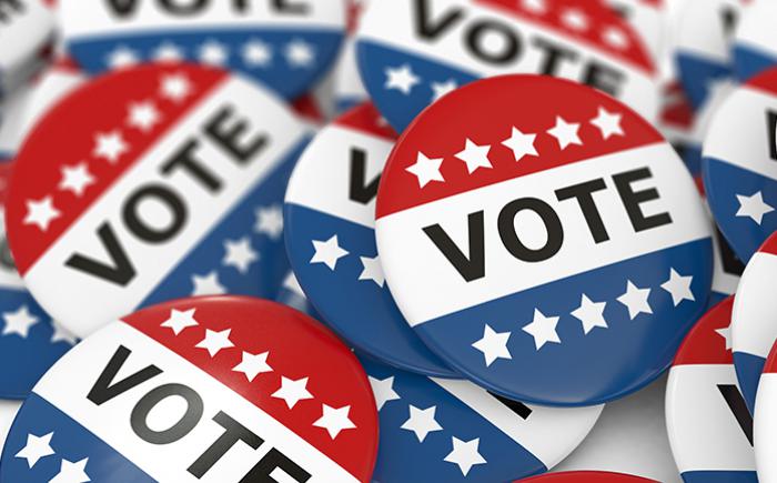 Image of red, white and blue "vote" pins