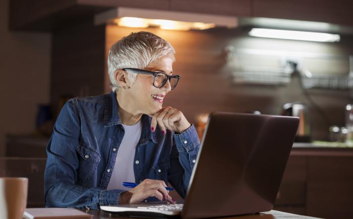 Woman at a laptop in a kitchen