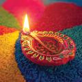 Diya surrounded by brightly colored rice