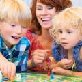 Children and parent playing a board game
