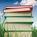 Stack of books in grass