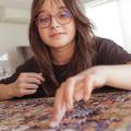 Young adult putting together a jigsaw puzzle