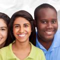 Four teens in brightly colored shirts