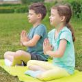 Two children in a yoga pose outdoors