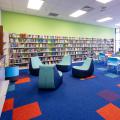 Tables and chairs and bookshelves inside teen area