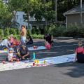 Families painting in parking lot across from Old Worthington Library