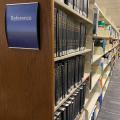 Reference sign in foreground, with bookshelves stretching off in the background