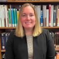 Headshot of Lauren Robinson in front of library bookshelves