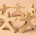 Seven wooden people figures positioned in a circle