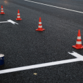 A parking lot with orange traffic cones that is currently undergoing repairs.