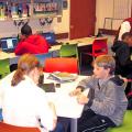 Northwest Library Homework Help Center filled with students and adult volunteers.
