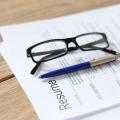 Resume on a table with a pen and glasses