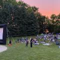 An audience watching a movie outdoors at Northwest Library backyard.
