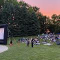 An audience watching a movie outdoors at Northwest Library backyard.