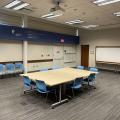 Table and chairts set up in the center of a meeting room