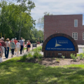A group of patrons being led during a Worthington Walks program in front of Old Worthington Library