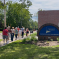 A group of patrons being led during a Worthington Walks program in front of Old Worthington Library