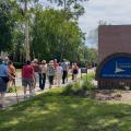 A group of patrons being led during a Worthington Walks program in front of Old Worthington Library