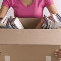 Woman holding a box partially filled with books