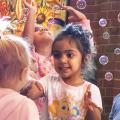Children playing among bubbles at Northwest Library