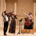 Members of Carpe Diem String Quarter in formal wear on stage